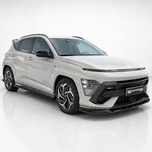 White compact SUV with black trim and large alloy wheels showcased in a bright studio setting.