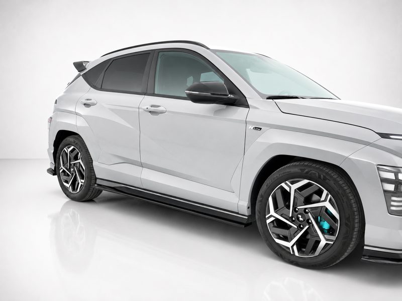 White SUV shown in a three-quarter front view in a studio with a clean gray background.