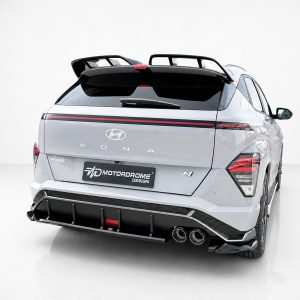 K219-003_2jpg - OPSHOLDERS Rear view of a silver Hyundai Kona N with a large rear spoiler and Motordrome Design body kit in a studio setting.