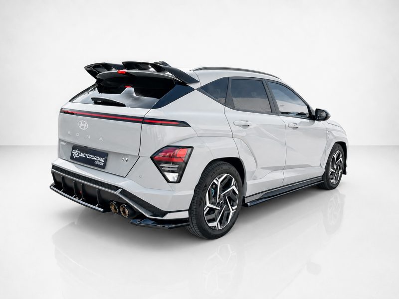 K219-003_3jpg - OPSHOLDERS Rear three-quarter view of a white Hyundai Kona-style SUV with a large aftermarket rear spoiler and racing-style wheels in a studio setting