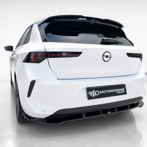 Rear view of a white Opel SUV with a black roof spoiler and a Motordrome Design license plate.