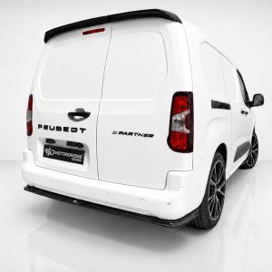 Rear three-quarter view of a white Peugeot Partner van in a studio, showing branding on the back doors and a Motordrome Design plate on the bumper area.
