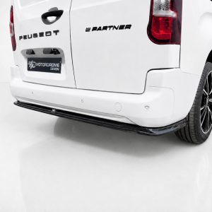 Rear three-quarter view of a white Peugeot van showing the 'Partner' badge, tail light, and a black rear bumper with a Motordrome Design plate.