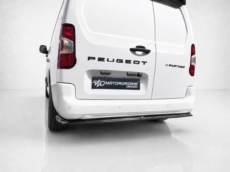Rear view of a white Peugeot Partner van showing the Peugeot badge and 'E Partner' lettering on the back door, with a Morodrome Design plate.
