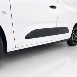 White van seen from the side with a black running board along the lower body edge.