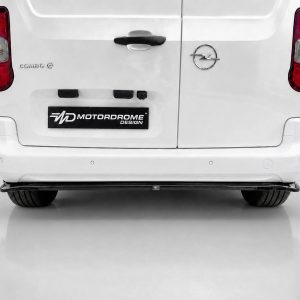 Rear view of a white van with two rear doors, Opel badge on the right, and a Motordrome Design plate in the center.