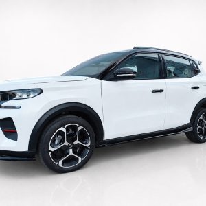 White compact SUV in a three-quarter front view, showing black roof rails and stylish alloy wheels on a glossy floor.