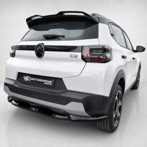 Rear view of a white SUV concept car with a black spoiler and prominent tail lights, featuring a MotorDrome Design plate on the bumper and a large wheel visible at the right edge.