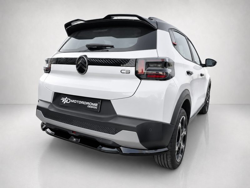 Rear view of a white SUV concept car with a black spoiler and prominent tail lights, featuring a MotorDrome Design plate on the bumper and a large wheel visible at the right edge.