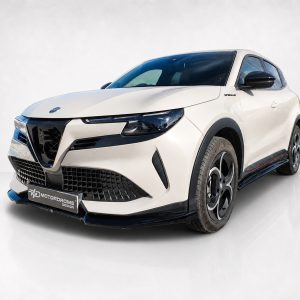 Front-left three-quarter view of a white compact SUV with a bold black grille and sporty styling.