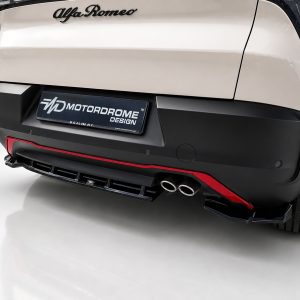 K227-003_3jpg - OPSHOLDERS Rear of a white Alfa Romeo with a MOTORDROME DESIGN plate and dual exhaust pipes at the bumper edge.