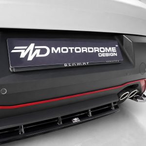 K227-003_4jpg - OPSHOLDERS Rear view of a car bumper with a Motordrome Design license plate and dual exhaust tips on the right side.