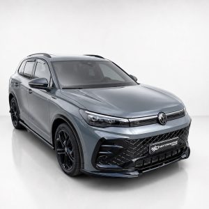 K228-001_2jpg - OPSHOLDERS Grey Volkswagen SUV in a studio setting, front angled view showcasing its bold grille and alloy wheels.