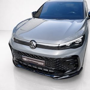 K228-001_4jpg - OPSHOLDERS Front view of a silver Volkswagen with a black mesh grille and sharp LED headlights in a studio setting.