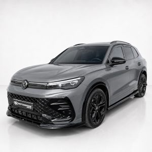 Gray Volkswagen SUV in a studio, front three-quarter view with black grille and large black wheels.