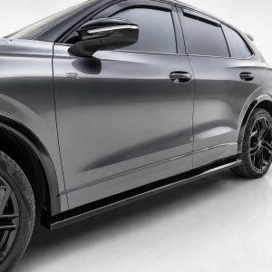 Side view of a gray SUV with black alloy wheels, showing door, mirror, and running board details