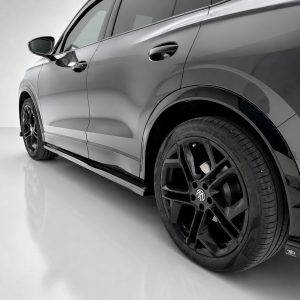 Side view of a gray SUV showing a glossy body, black alloy wheel and lowered side skirt that runs along the bottom.