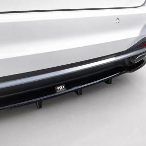 Close-up of a white SUV rear bumper with a black side skirt/step rail and a small MD badge sticker underneath