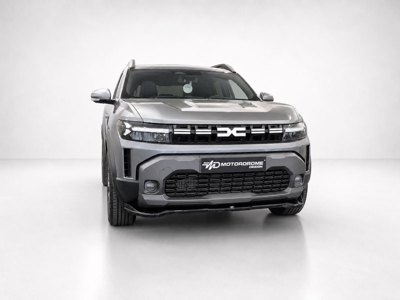 Front view of a silver SUV in a bright studio, with a bold black grille and MD Motordrome Design plate on the bumper.