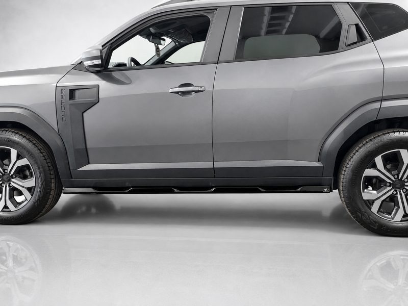 Side view of a gray Ford Ranger pickup truck, showing the front door and wheel on a clean backdrop.