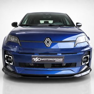 Front view of a blue Renault car in a studio, showing the emblem, grille, and headlights with a Motordrome Design plate visible on the bumper.