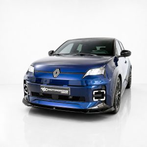 Front three-quarter view of a blue Renault compact car with a diamond logo, in a white studio setting.