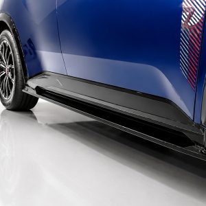 Close-up of a blue car's lower side panel with a black aerodynamic side skirt and visible wheel.