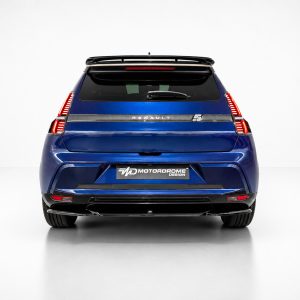 Rear view of a blue SUV with a roof spoiler, vertical taillights, and a rear wiper, featuring a Renault badge and a Motordrome Design plate on the bumper.