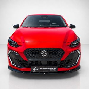 Front view of a bright red Renault sports car with a large black honeycomb grille and diamond emblem in the center