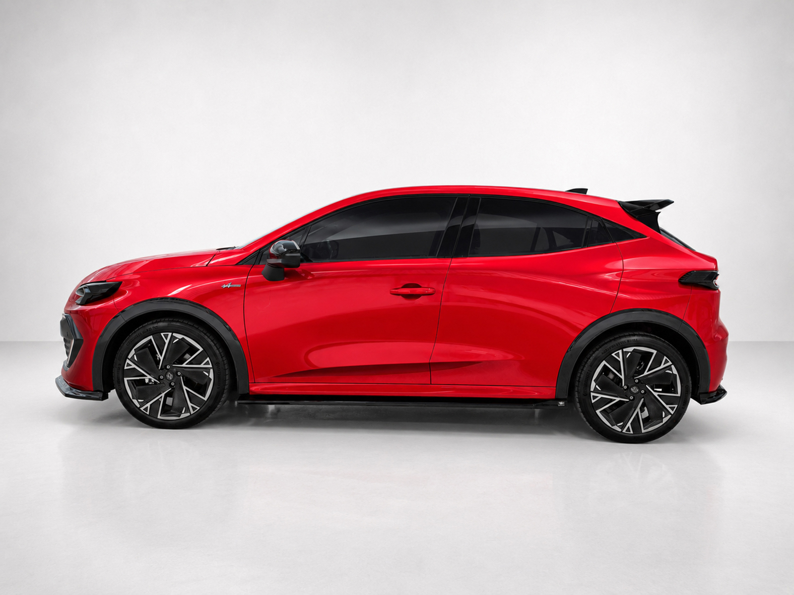 K233-002_2jpg - OPSHOLDERS Side view of a bright red sporty hatchback with black trim and large alloy wheels in a studio setting