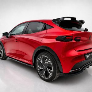 K233-002_4jpg - OPSHOLDERS Red sporty crossover car shown from the rear-three-quarter angle in a studio, with large black alloy wheels and glossy finish.