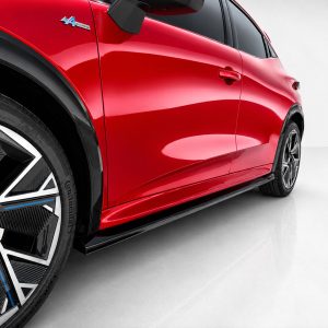 K233-002_6jpg - OPSHOLDERS Red car side panel and large black alloy wheel with blue trim, viewed from a low angle.