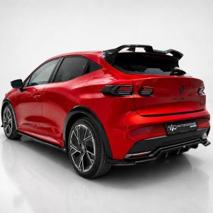 Red Renault Clio hatchback, photographed from the rear-left, with a sporty spoiler and large alloy wheels.