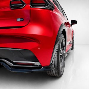 Red sports car rear quarter panel with taillight, bumper, and large alloy wheel in a studio setting.
