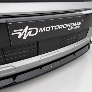 Front view of a silver car with a black plaque reading MOTORDROME DESIGN on the bumper area.
