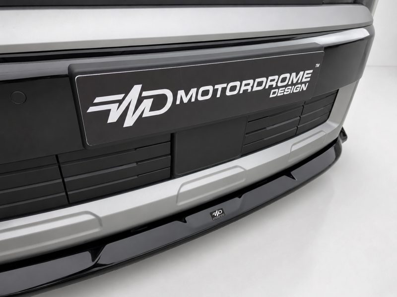 Front view of a silver car with a black plaque reading MOTORDROME DESIGN on the bumper area.