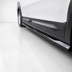 Side view of a white van with a chrome running board along the lower edge and a visible wheel.