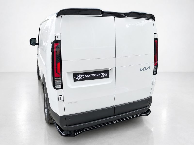 Rear view of a white cargo van with split rear doors, black bumper, and red tail lights; Motordrome Design badge on the lower left door area.