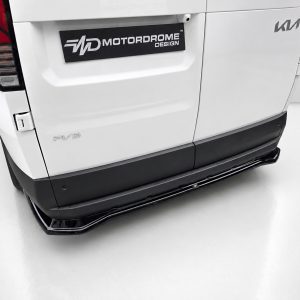 Rear view of a white van featuring a Motordrome Design plate, a Kia badge, and a black running board along the bumper.