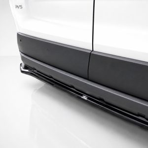 Close-up of a white vehicle's lower side, showing black rocker panel and a chrome running board/step.