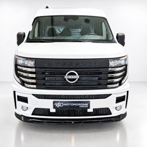 Front view of a white Nissan Interstar van in a bright studio setting with the grille and logo centered.