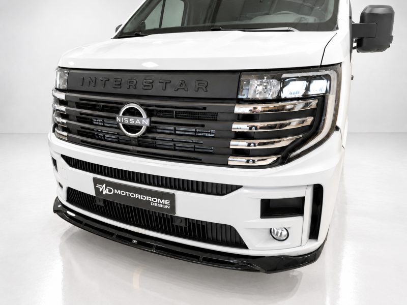 Front view of a white Nissan Interstar van, highlighting the bold grille and logo.