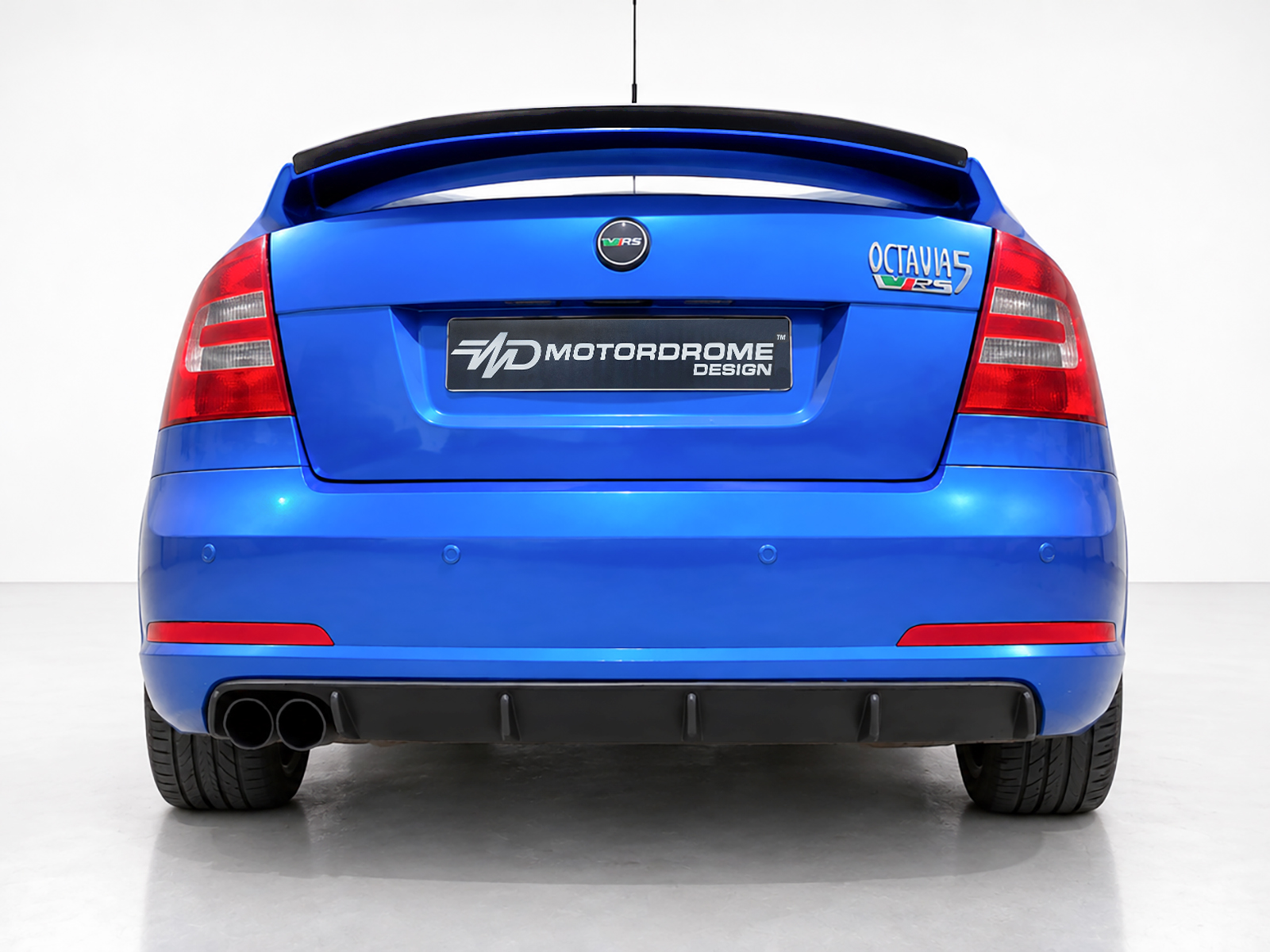 K43-008_1jpg - OPSHOLDERS Blue car rear view featuring Octavia RS badge and MotorDrome Design plate on a clean white backdrop.