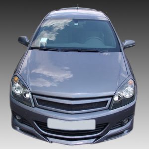 Front view of a gray sedan facing the camera, showing headlights and grille