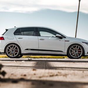 Mk8-GTI-Racingline-Lowering-Springs-scaled-2jpg - OPSHOLDERS White luxury SUV photographed in a side view, framed by dark metal pillars outdoors on a sunny day