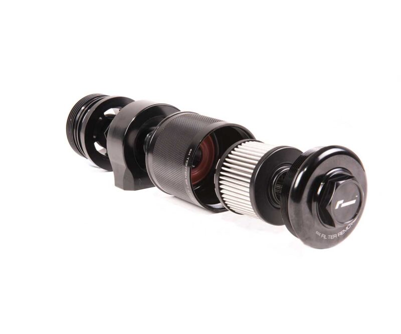 Disassembled black camera lens laid out horizontally on a white background, showing barrel, rings, and front element