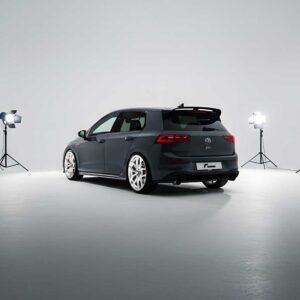 Gray Volkswagen GTI wagon photographed in a white photography studio with four bright lights surrounding the car.
