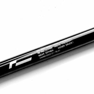 Close-up of a black cylindrical tube with a multilingual warning: 'Do not open – High pressure' along its length