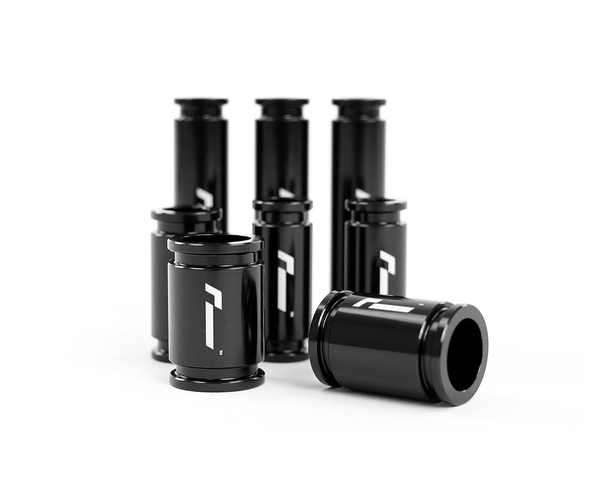 Racingline-DSG-Gearbox-Billet-Oil-Feed-Tubes-DQ500-DQ381-VWR040302jpg - OPSHOLDERS Five black glass bottles with white logos standing on a white surface, one bottle lying on its side.