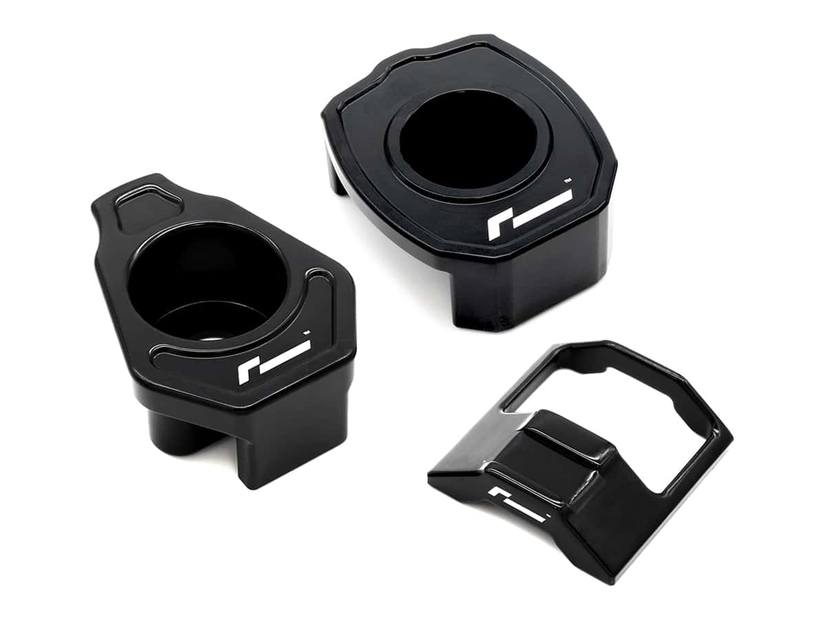 Racingline-Dogbone-Mount-Insert-1jpg - OPSHOLDERS Three black plastic mounting adapters with circular openings and a white logo, arranged on a white background.